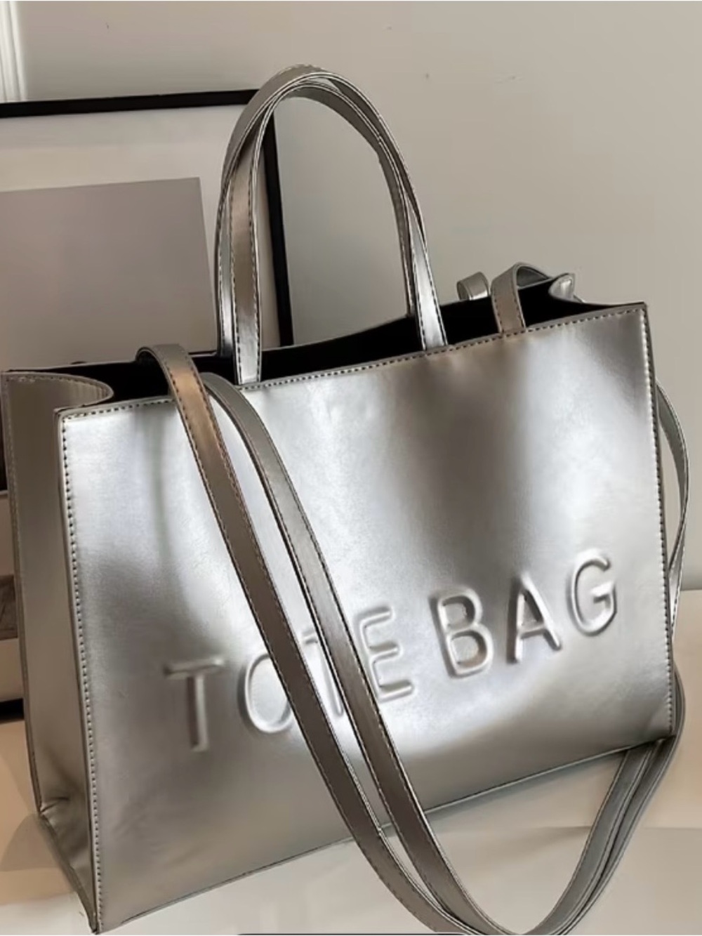Metallic Silver Tote Bag with Embossed 'TOTE BAG' Branding